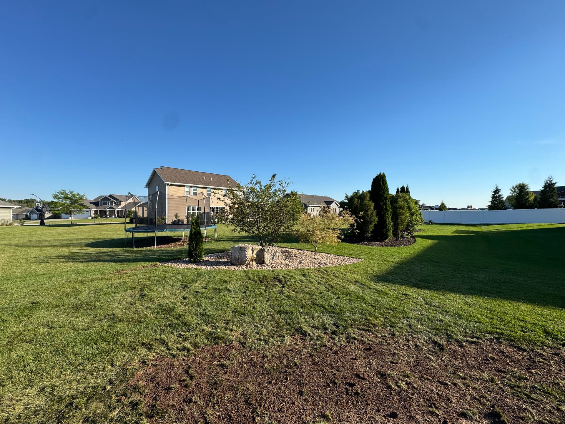 Gallery photos for Rock Beds and Arborvitaes Replace Worn Mulch in This Backyard: Image #1